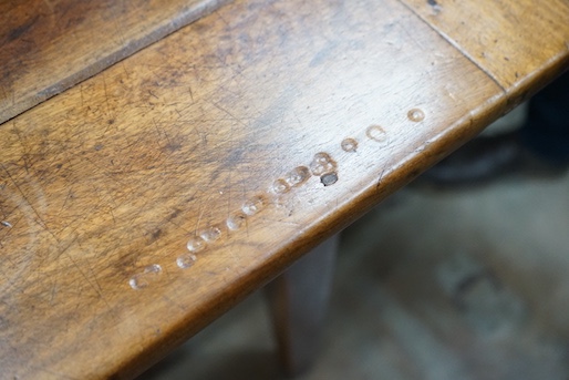 An early 19th century French rectangular fruitwood kitchen table fitted two drawers, length 201cm, depth 80cm, height 76cm